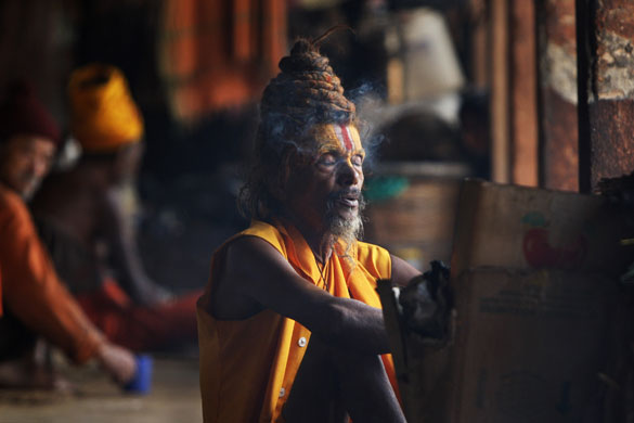 24 hours in pictures: Katmandu, Nepal: A Hindu holy man smokes at the Pashupatinath temple