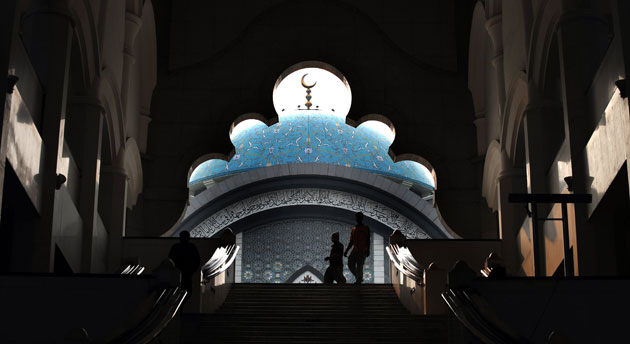 24 hours in pictures: Kuala Lumpur, Malaysia: Worshippers leave a mosque after noon prayer