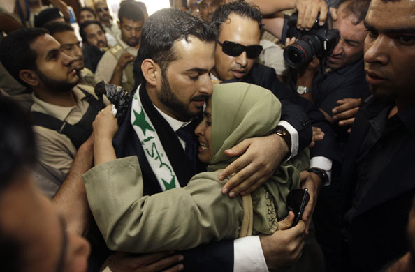 al Zaidi released: Muntazer al-Zaidi embraces his sister  following his release from prison