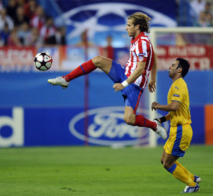 2 champions league: Atletico Madrid forward Diego Forlan leaps up and controls the ball