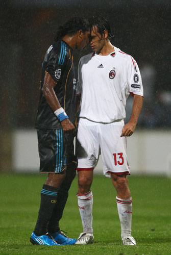 3 champions league: Brandao of Marseille, left, squares up to Alessandro Nesta of Milan