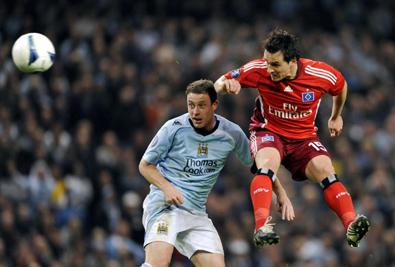 Man City: Hamburg's Piotr Trochowski (R) heads the