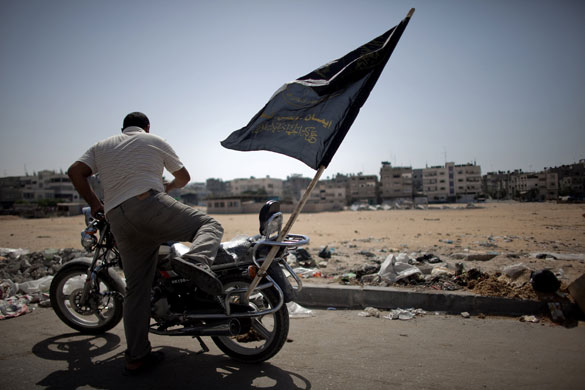 24 hours in pictures: A Palestinian man hops on his motorbike during an Al-Quds