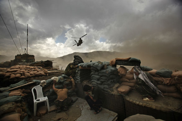 24 hours in pictures: oldiers of the Afghan National Army duck for cover