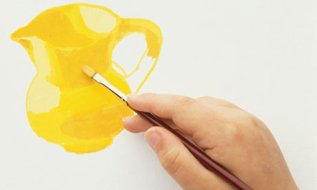 Hand holding paint brush