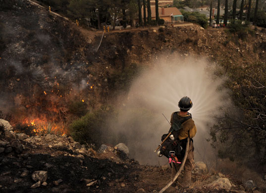 Wildfires California: Firefighter sprays water during the Station Fire in La Crescenta California