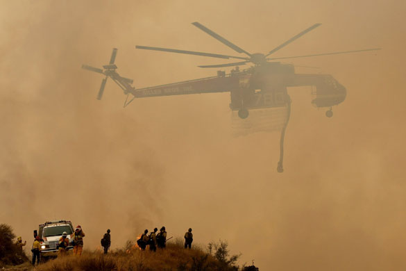 Wildfires California: A firefighting helicopter prepares to drop water on hot spots 
