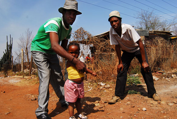 Chiawelo in Soweto: Earnest Molefe, right, and Vusi Mtembo with his little daughter Thembi  
