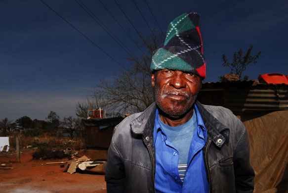 Chiawelo in Soweto: Justice Mafisa stands in front of his shack. He does not want to move 