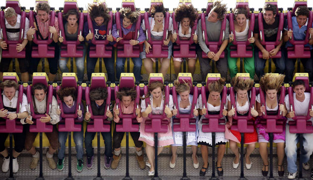 24 hours in pictures: People on a roller coaster at the beer festival Oktoberfest in Munich