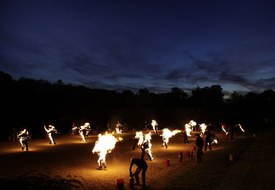 24 hours in pictures: 17 people walk around engulfed in fire for Guiness Book of Records