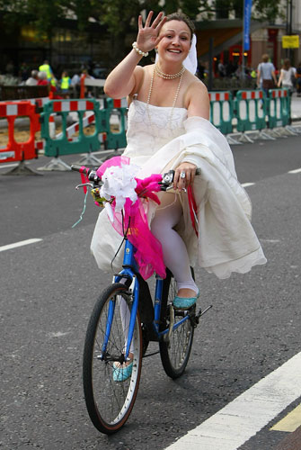 London's Skyride: A woman cycles in a wedding dress