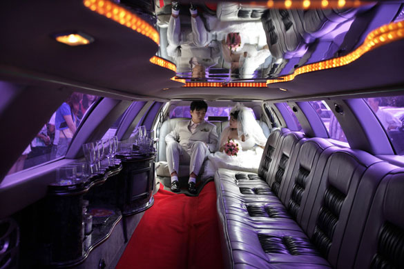 21 September 2009: Shanghai, China: A couple sit in a Lincoln Limousine