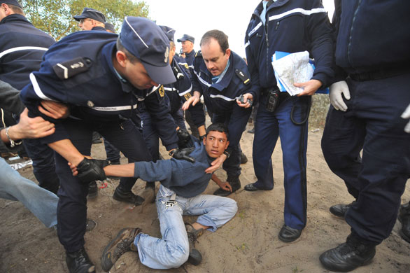 Calais jungle camp: Immigrants are detained by officials at Calais jungle camp