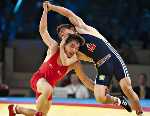 World Wrestling Champs: Kyong-II Yang of North Korea attempts to flip over Turkey's Sezar Akgul