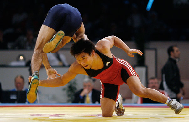 World Wrestling Champs: Turkmenistan's Ramazan Kambarov dives over the arm of Kazakhstan's Zhosulan