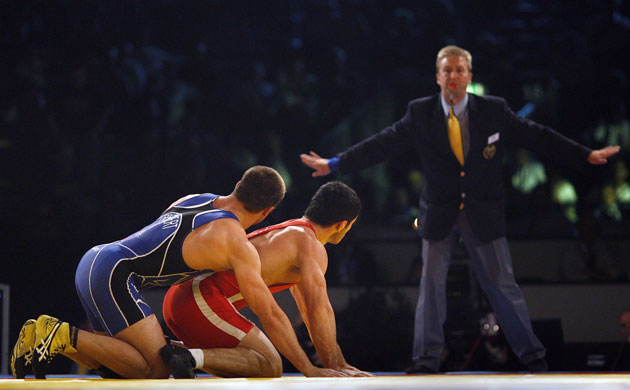Wrestling: Uzbekistan's Sokhiev and Herbert of the U.S. watch the referee