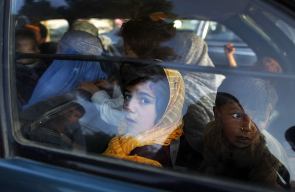 23 September 2009: Kabul, Afghanistan: Children peer out of a car after visiting a park