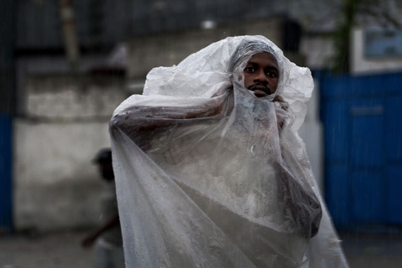 23 September 2009: Port-au-Prince, Haiti: A man peers through a plastic sheet