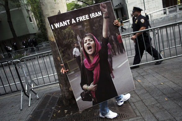 24 hours in pictures: A demonstrator carries a sign near the United Nation in New York