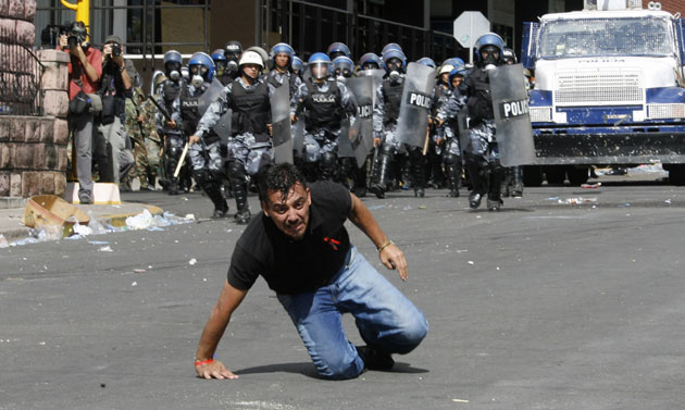 24 hours in pictures: Zelaya supporterhit by tear gas shot by riot police in Teguciglapa