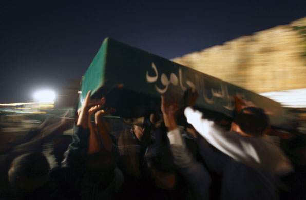 24 hours in pictures: Mourners carry the coffin of Rabia Tawil 