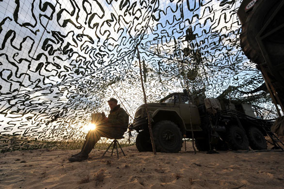25 September 2009: Volka, Russia: A Belarussian soldier using a laptop computer
