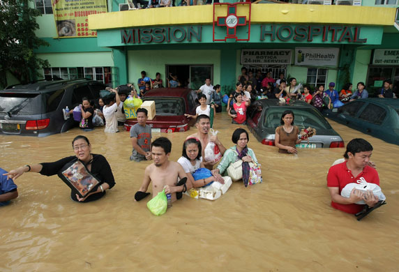 Philippines floods: Filipinos plead for help as they evacuate a flooded hospital in Cainta