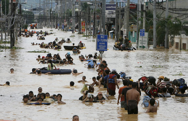 Philippines floods: Residents wade in floodwaters in Cainta Rizal east of Manila