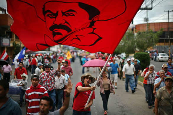 Honduras crisis: A supporter of ousted Honduras' President Manuel Zelaya waves a flag