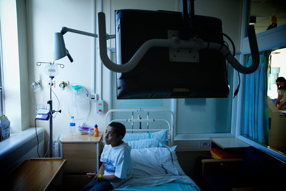 Alder Hay Hospital: A little boy sits on the edge of his hospital bed