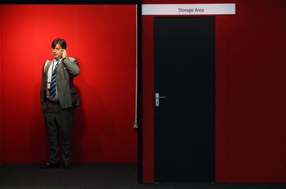 Labour Party Conference: A delegate speaks on his mobile phone in amongst trade stalls 