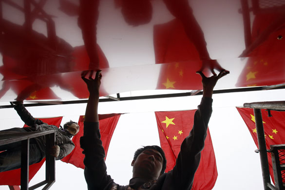 29 September 2009: Beijing, China: Workers prepare decorations