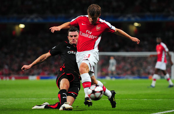 Tuesday Champions League: Michal Zewlakow slides in and tackles Arsenal's Andrey Arshavin 