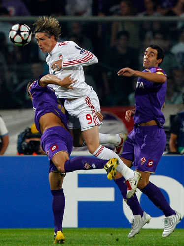 Tuesday Champions League: Liverpool's Torres jumps for the ball with Dainelli & Gobbi of Fiorentina 