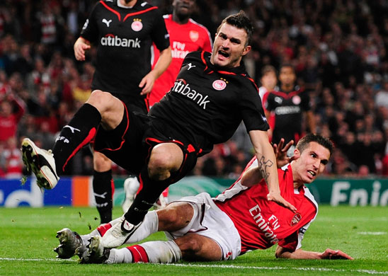 Tuesday3 Champions League: Robin van Persie of Arsenal fouls Michal Zewlakow of Olympiakos