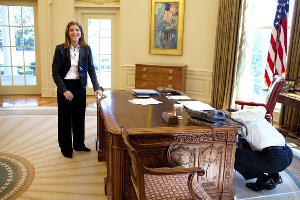 The Obama family: 3 March 2009: President Barack Obama examines the Resolute Desk