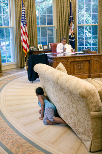 The Obama family: 5 August 2009: President Barack Obama's daughter Sasha hides behind a sofa