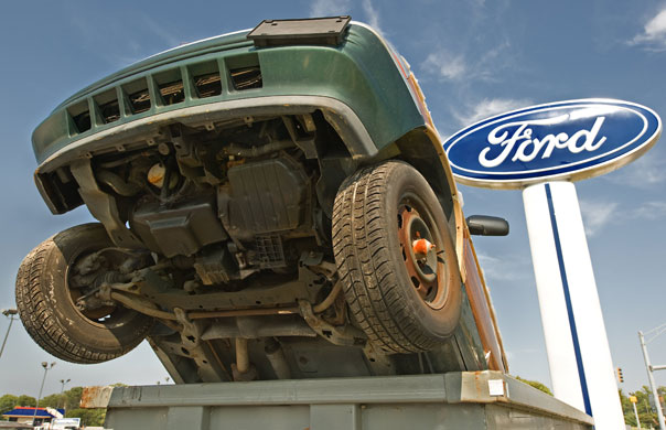 Business week in pictures: A Cash-for-Clunkers 4-wheel-drive vehicle sits in a dumpster