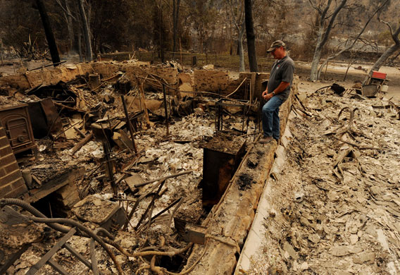 Wildfires in California: Homeowner Dave Johnson views his cabin destroyed by the Station Fire