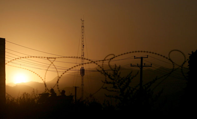 30 September 2009: Kabul, Afghanistan: Security men stand guard on their armored vehicles