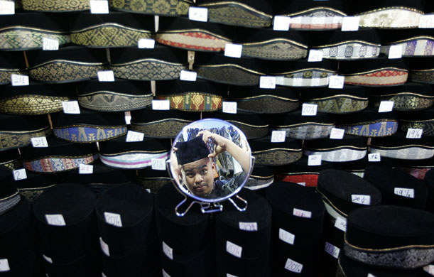 4 September 2009: Kuala Lumpur, Malaysia: A man is reflected in a mirror