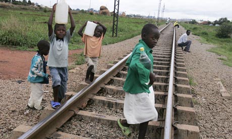 Children collect water in Harare, Zimbabwe