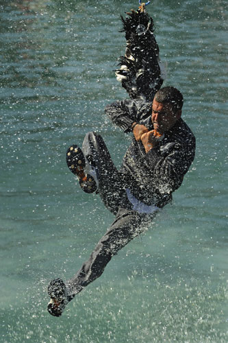 7 September 2009: Lekeito, Spain: A man jumps in the air and grabs hold of a goose