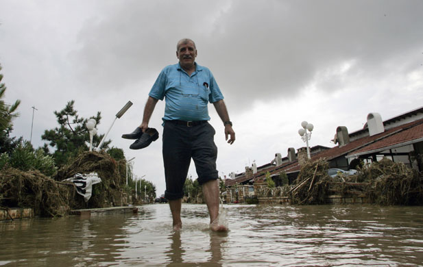 Flooding in Turkey: A man walks in floodwater in Selimpasa, a suburb of Istanbul