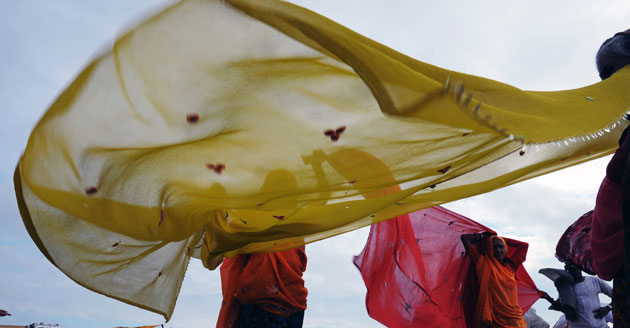 9 September 2009: Sangam, India: Hindu women dry their clothes