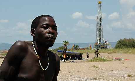 Fishermen near an oil rig on the edge of Lake Albert in western Uganda