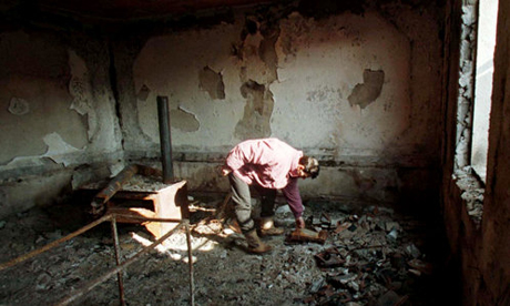 Albanian man in ruined house