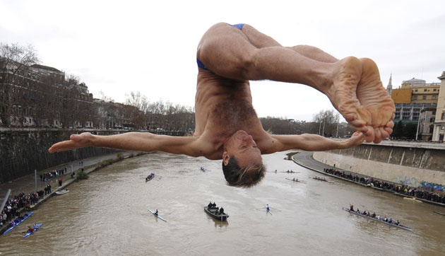 24 hours: A man dives into the Tiber River as part of  New Year celebrations 
