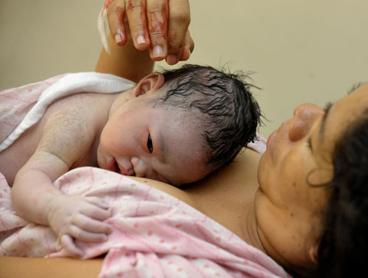 24 hours: Quezon city, Philippines: A mother after giving birth on New Year's day 